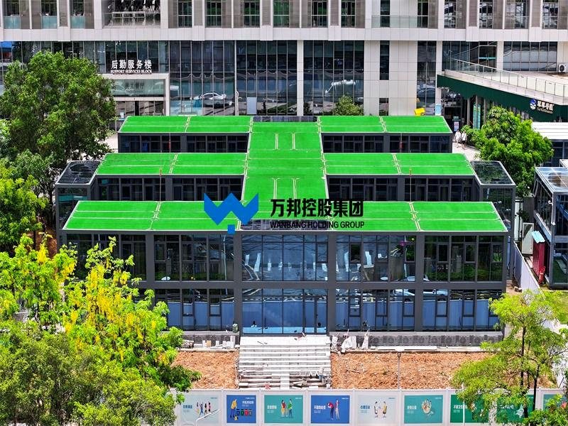 Modular building with green turf roof and glass curtain walls in urban setting