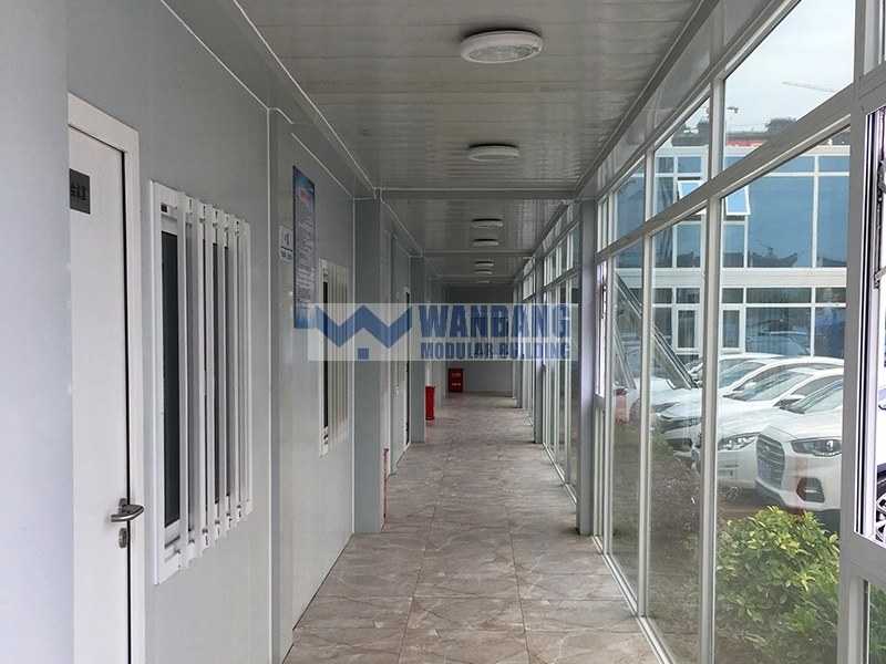 Interior corridor with glass doors and parking lot visible outside