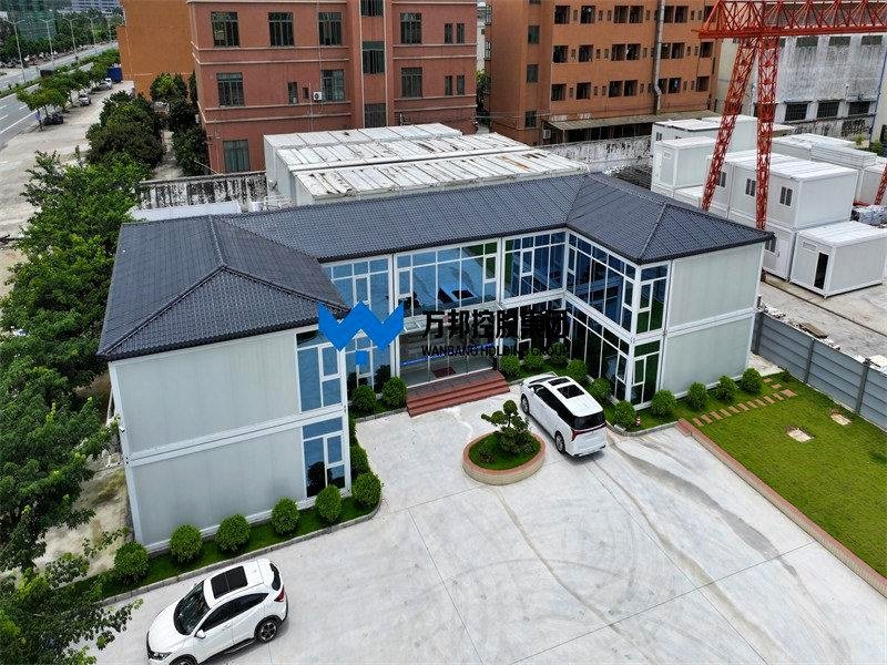 Aerial view of completed two-story modular building project with dark roof and parking lot